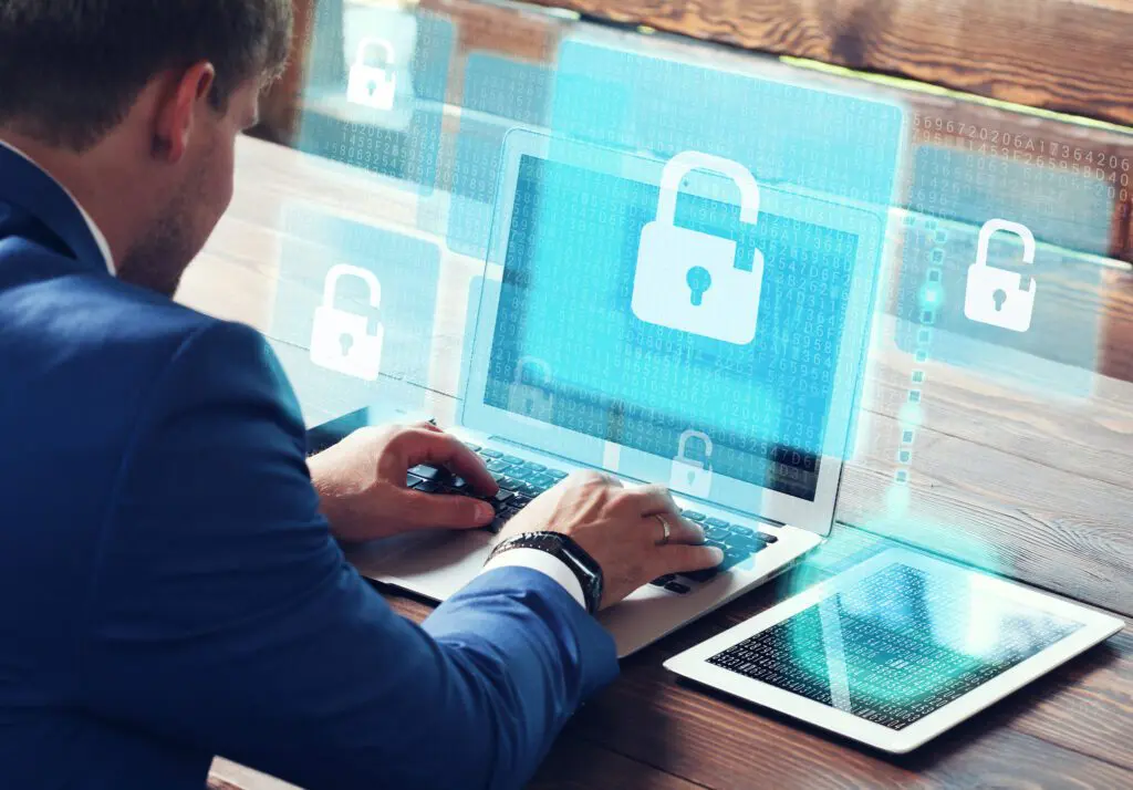 Business man working with sensitive data on a screen displaying a lock for digital fraud prevention.