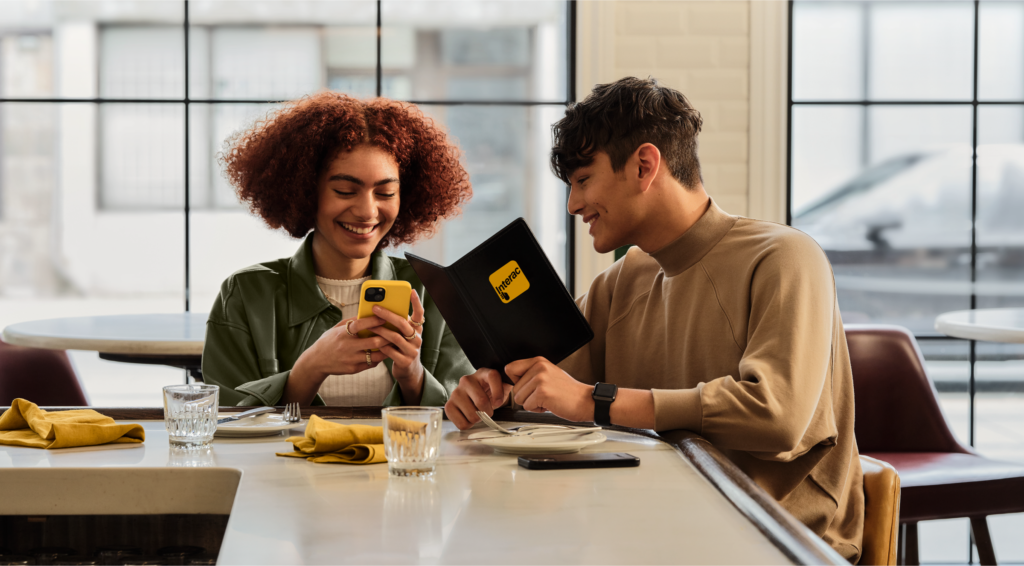 Two people laughing at a diner