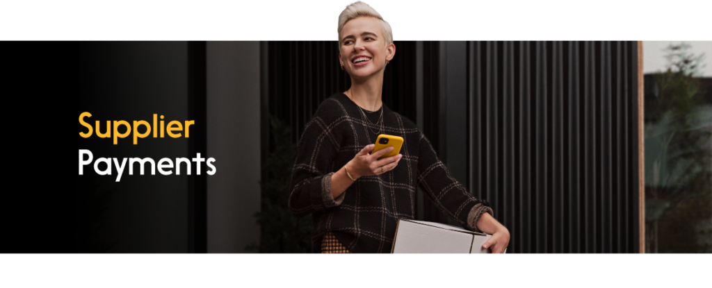 A person holding a package and a phone
