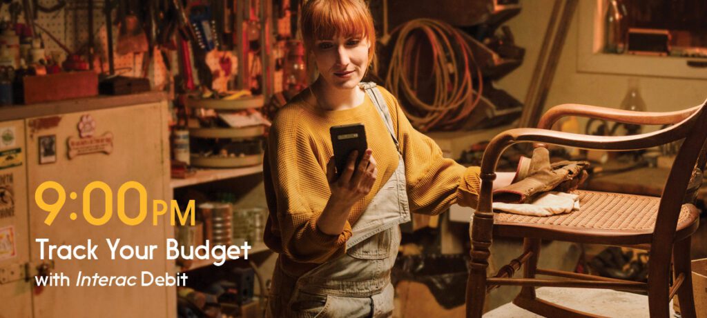 Shoop owner looks at phone as she plans her personal budget.