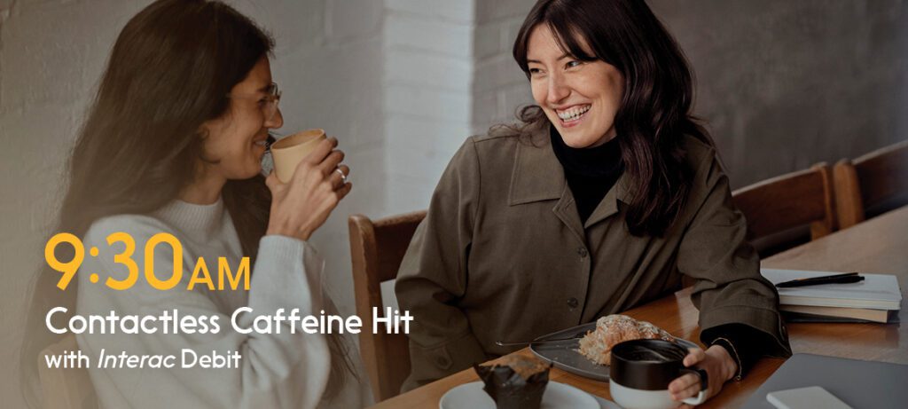 Women supporting local restautrant by using contactless payment to buy coffee.