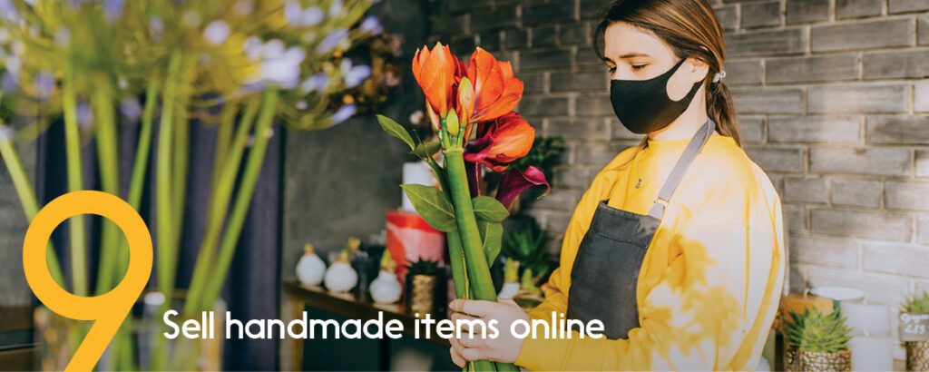 A florist prepares a bouquet of red flowers for a client who used e-transfer to pay. 