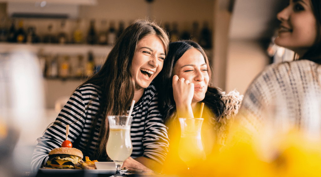 Happy friends dining at restaurant