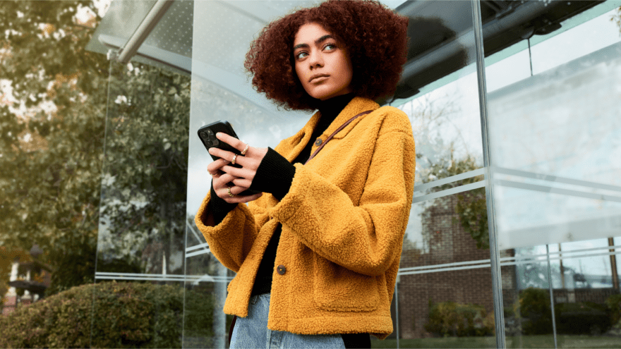 Woman looking pensive while holding her phone