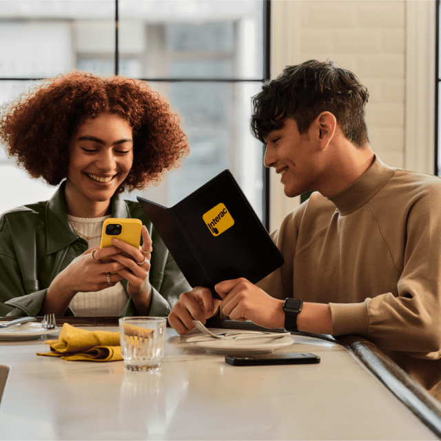 Two people laughing at a diner