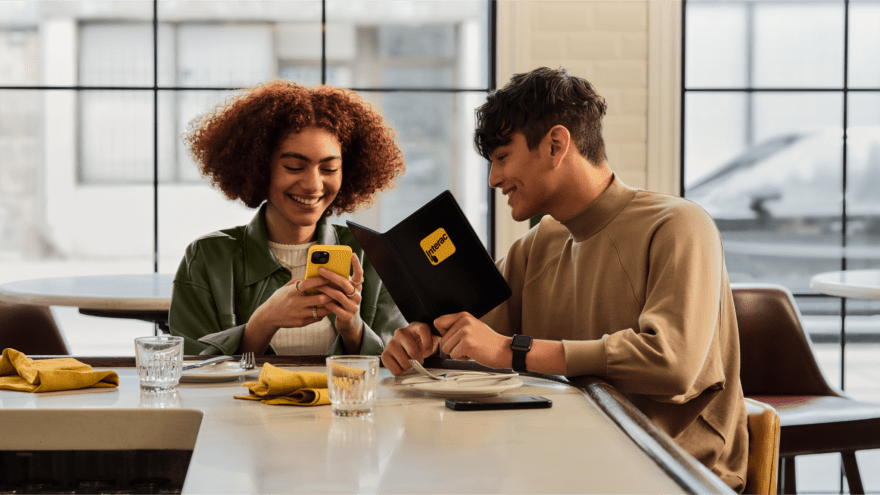Two people laughing at a diner